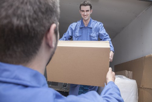 Small removals van handling furniture in Ealing
