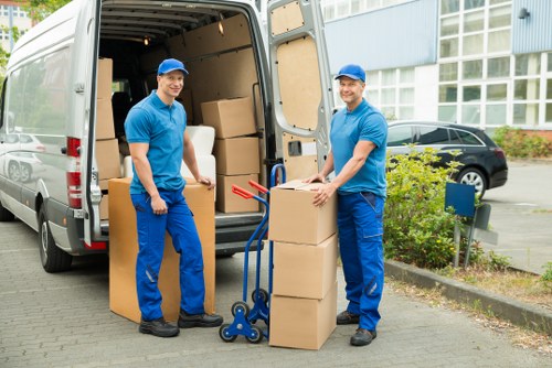 Professional movers handling furniture during house removals in Ealing